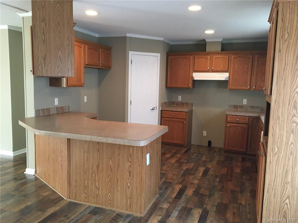 4860 Yoder Road Crouse, NC 28033 - Photo 7 of 20 a kitchen with stainless steel appliances a sink a stove a refrigerator cabinets and a window