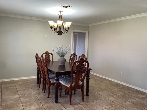 a view of a dining room with furniture and chandelier