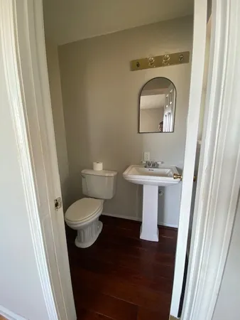 a bathroom with a toilet sink and mirror