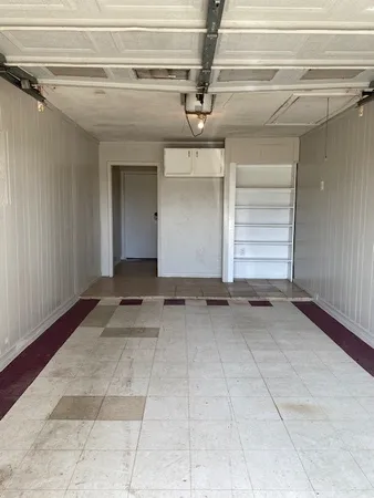 a view of a backyard with plants and large trees