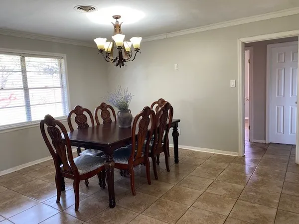 a view of a dining room with furniture and chandelier