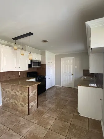 a kitchen with stainless steel appliances kitchen island granite countertop a sink and cabinets
