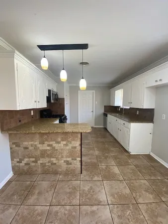 a large kitchen with cabinets
