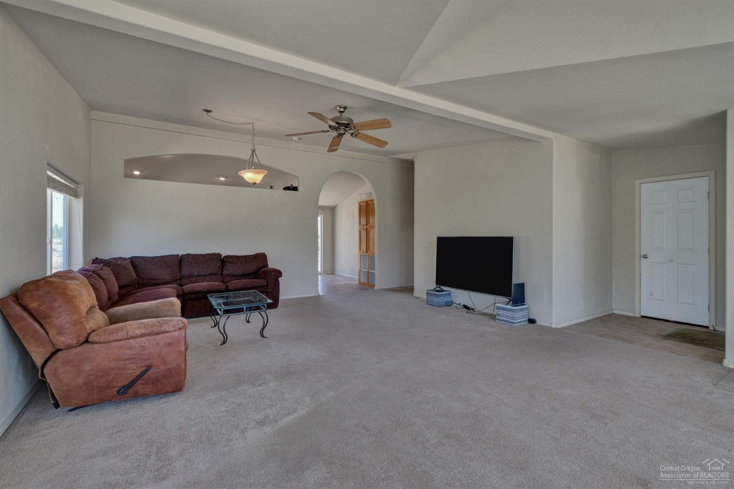 67252 Gist Road Bend, OR 97703 - Photo 4 of 24 a living room with furniture and a flat screen tv