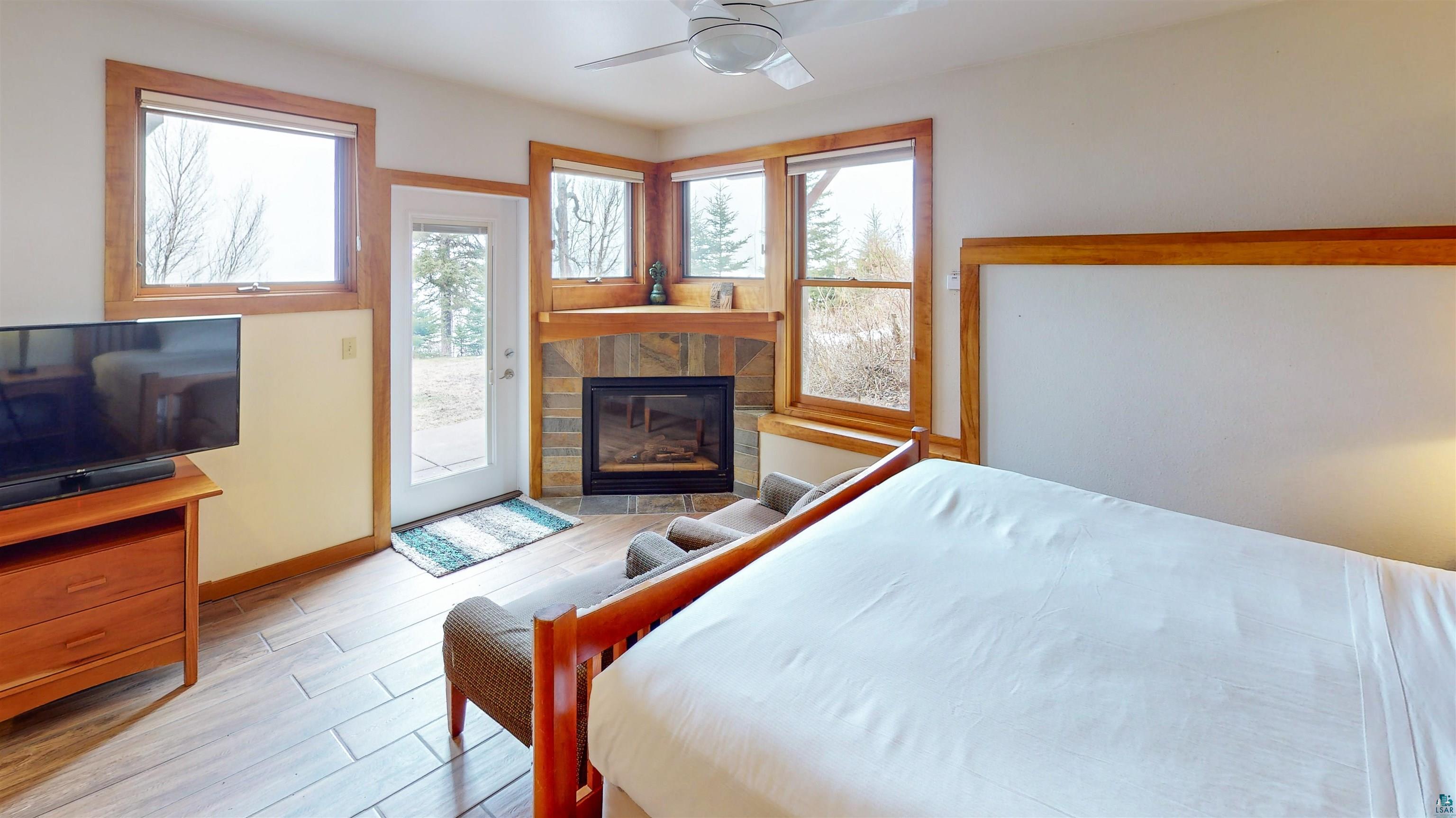 504-506 Poplar River Road, Unit 505 Lutsen, MN 55612 - Photo 28 of 39 Corner fireplace with stone surround and wood mantel