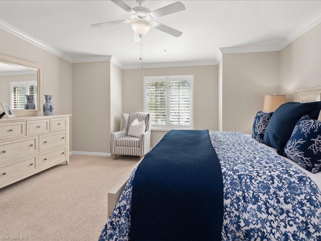 9532 Avellino Way, Unit 2726 Naples, FL 34113 - Photo 15 of 35 Bedroom with ornamental molding, light colored carpet, and a ceiling fan
