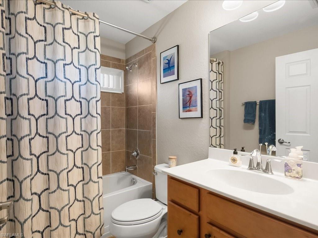 9532 Avellino Way, Unit 2726 Naples, FL 34113 - Photo 20 of 35 Full bath featuring vanity, shower / bath combo, and a textured wall