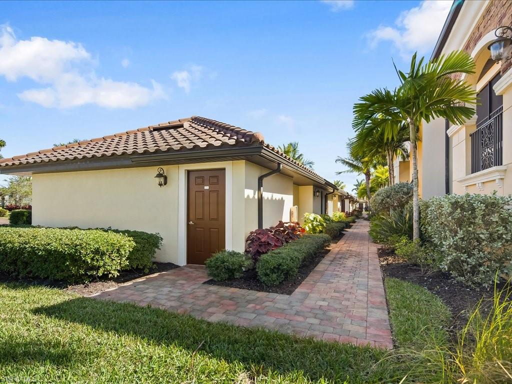 9532 Avellino Way, Unit 2726 Naples, FL 34113 - Photo 24 of 35 View of exterior entry featuring stucco siding and a tiled roof