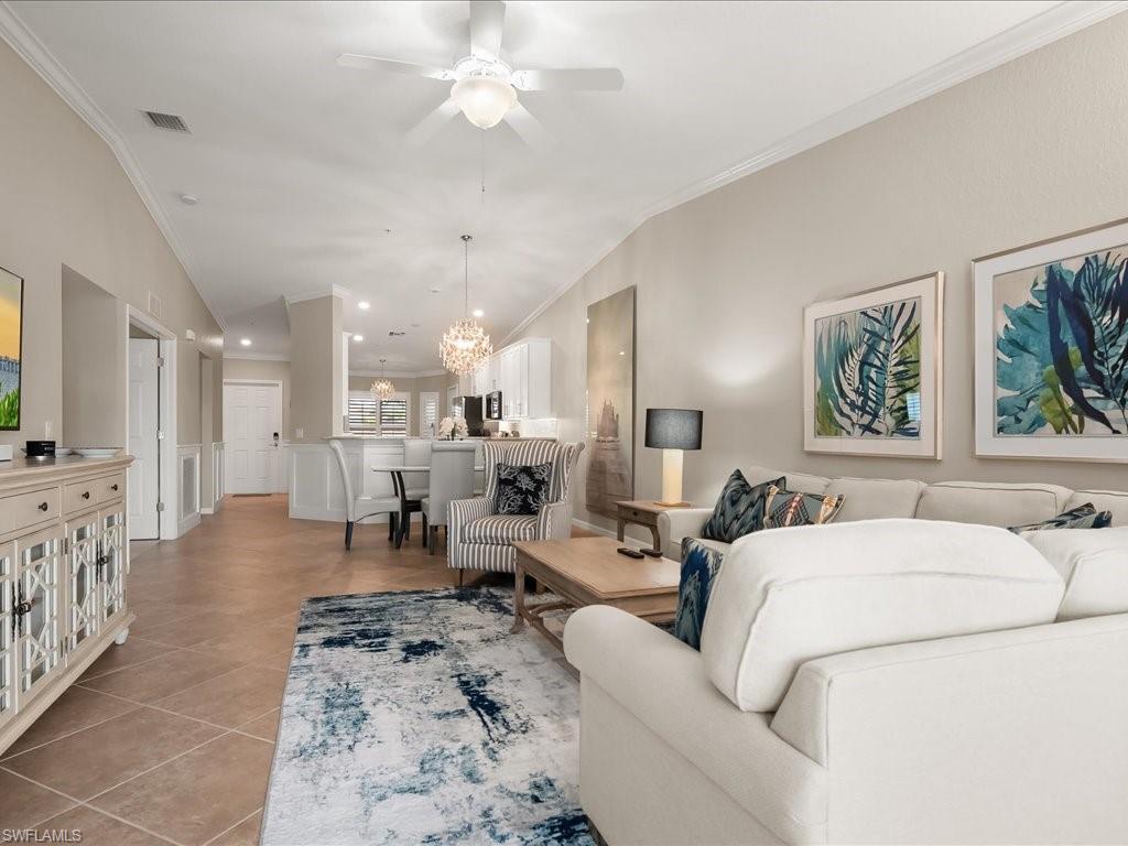 9532 Avellino Way, Unit 2726 Naples, FL 34113 - Photo 5 of 35 Living room featuring crown molding, a chandelier, light tile patterned floors, and ceiling fan