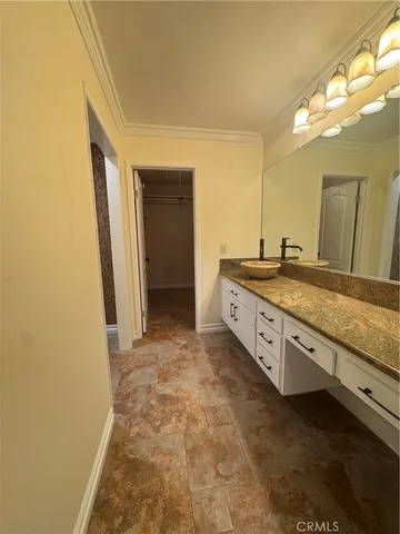 a spacious bathroom with a granite countertop sink and a mirror