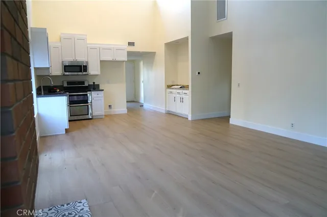 a kitchen with stainless steel appliances a refrigerator and a stove top oven