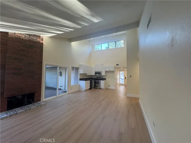 a view of a livingroom with a furniture wooden floor and window
