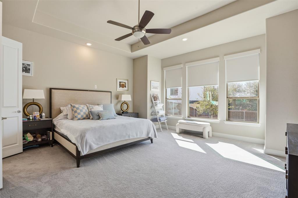 9435 Rockmount Drive Dallas, TX 75243 - Photo 13 of 32 a spacious bedroom with a bed and a large window