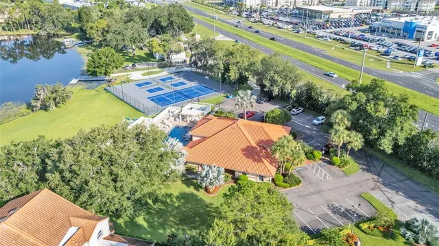 an aerial view of a house with a garden and lake view