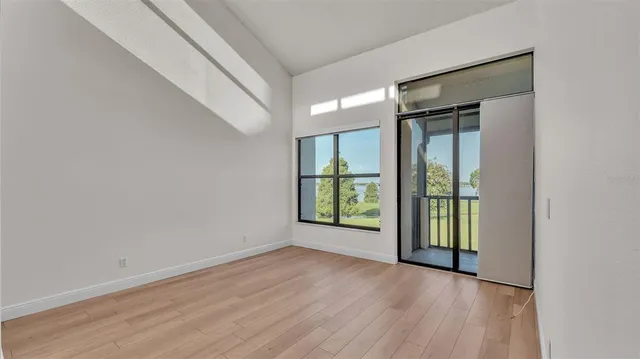 a kitchen with a refrigerator a sink and wooden floor