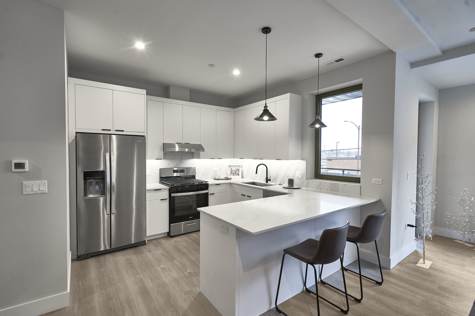 451 East Pershing Road, Unit 403 Chicago, IL 60653 - Photo 12 of 30 a kitchen with refrigerator cabinets and wooden floor