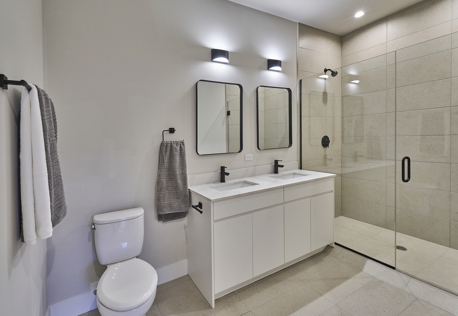 451 East Pershing Road, Unit 403 Chicago, IL 60653 - Photo 21 of 30 a bathroom with a toilet sink and mirror