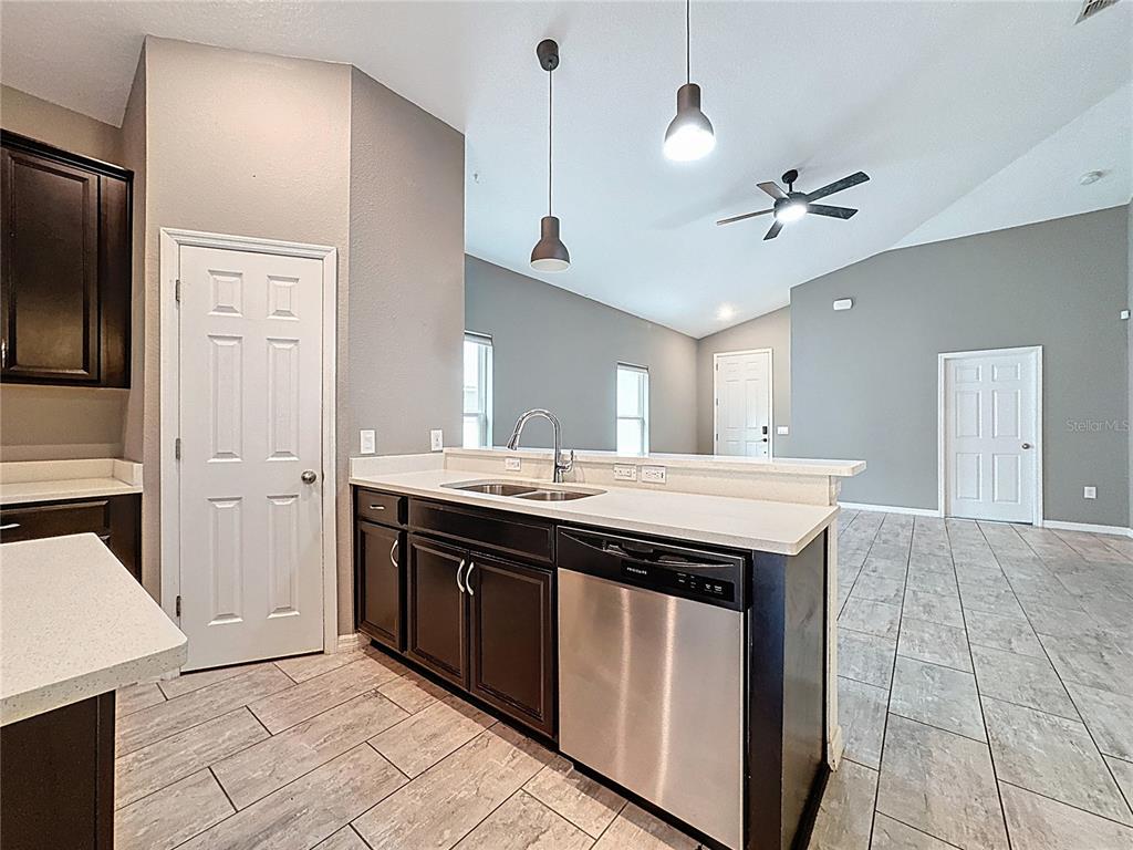 3477 Middlebrook Place Harmony, FL 34773 - Photo 26 of 78 a kitchen with a sink and refrigerator