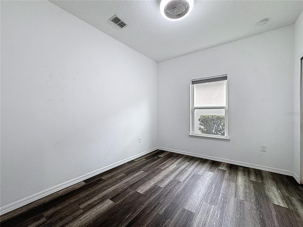 3477 Middlebrook Place Harmony, FL 34773 - Photo 32 of 78 an empty room with wooden floor and windows