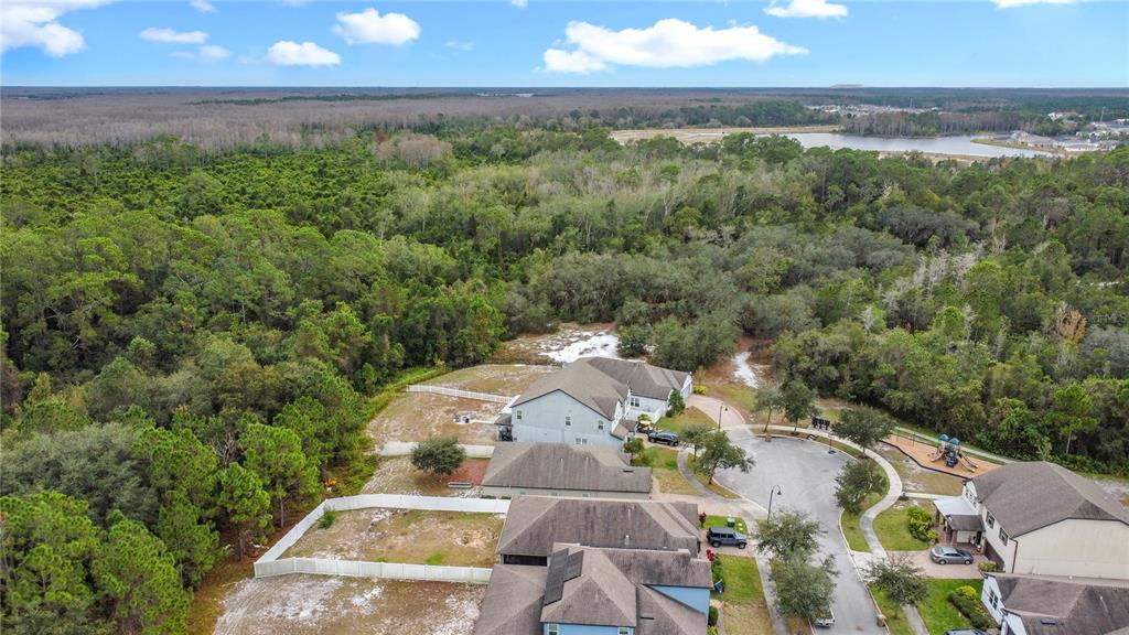 3477 Middlebrook Place Harmony, FL 34773 - Photo 58 of 78 an aerial view of a house with a yard and lake view