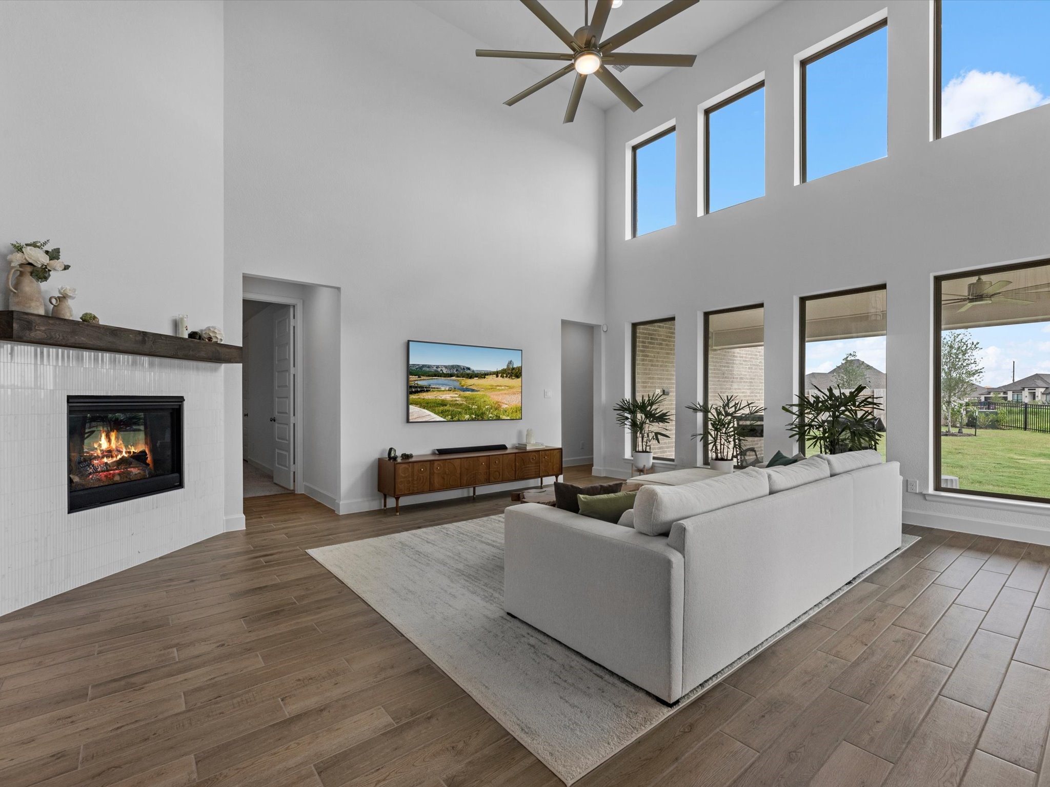 18714 Pistachio Way Manvel, TX 77578 - Photo 8 of 48 Gather around the gas-log fireplace, perfectly positioned to create a warm focal point while maintaining an open connection to the kitchen and dining areas.