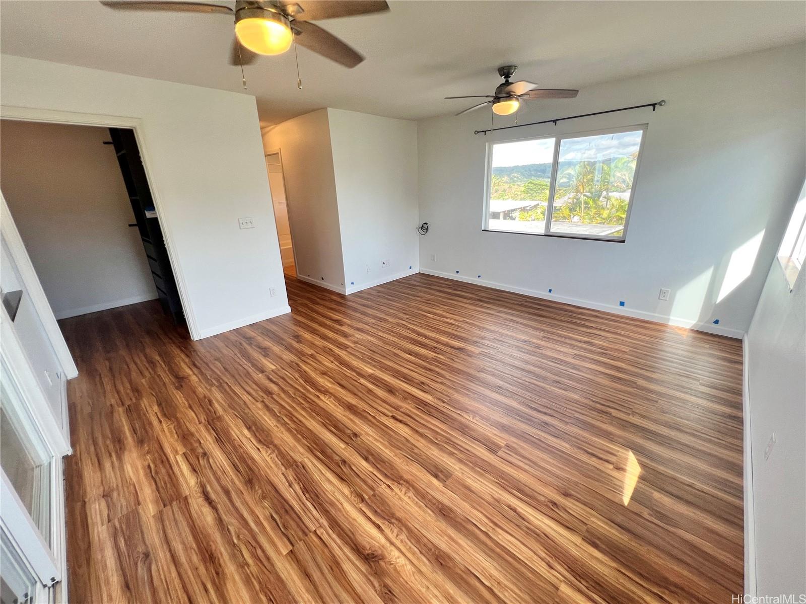 2407 Komo Mai Drive Pearl City, HI 96782 - Photo 14 of 25 a view of an empty room with wooden floor and a window
