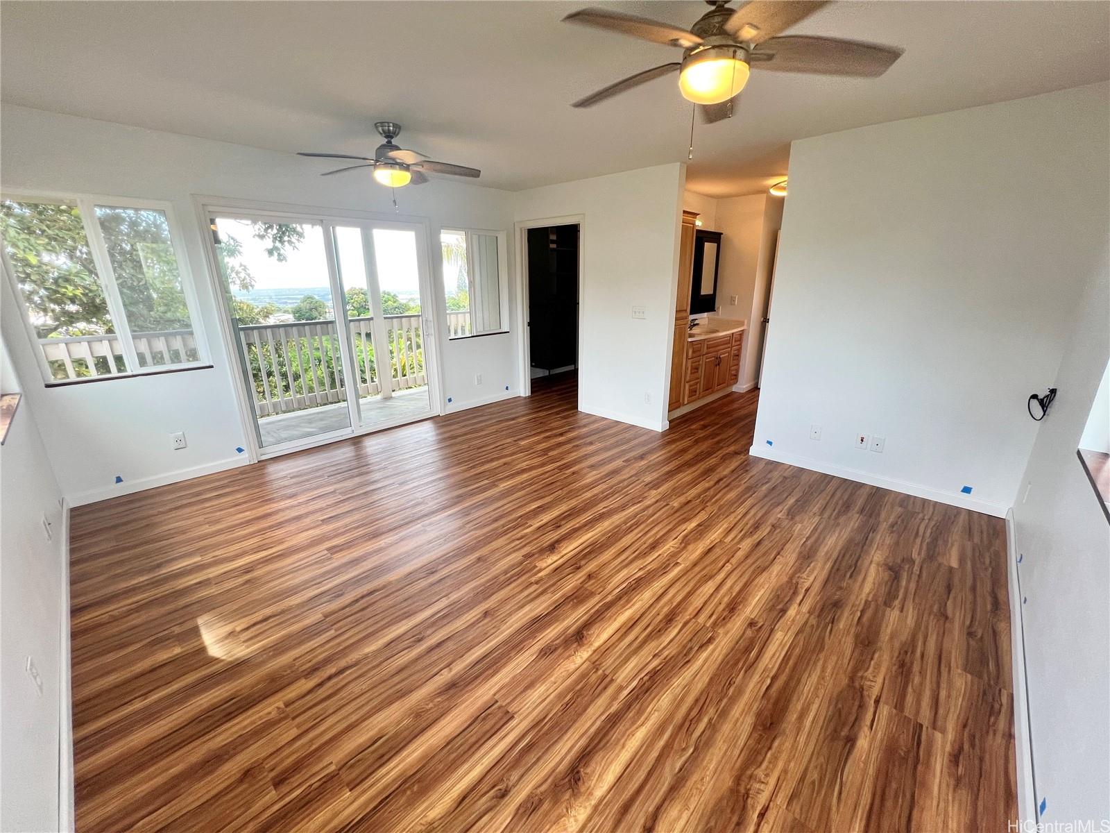 2407 Komo Mai Drive Pearl City, HI 96782 - Photo 15 of 25 a view of an empty room with wooden floor and a window