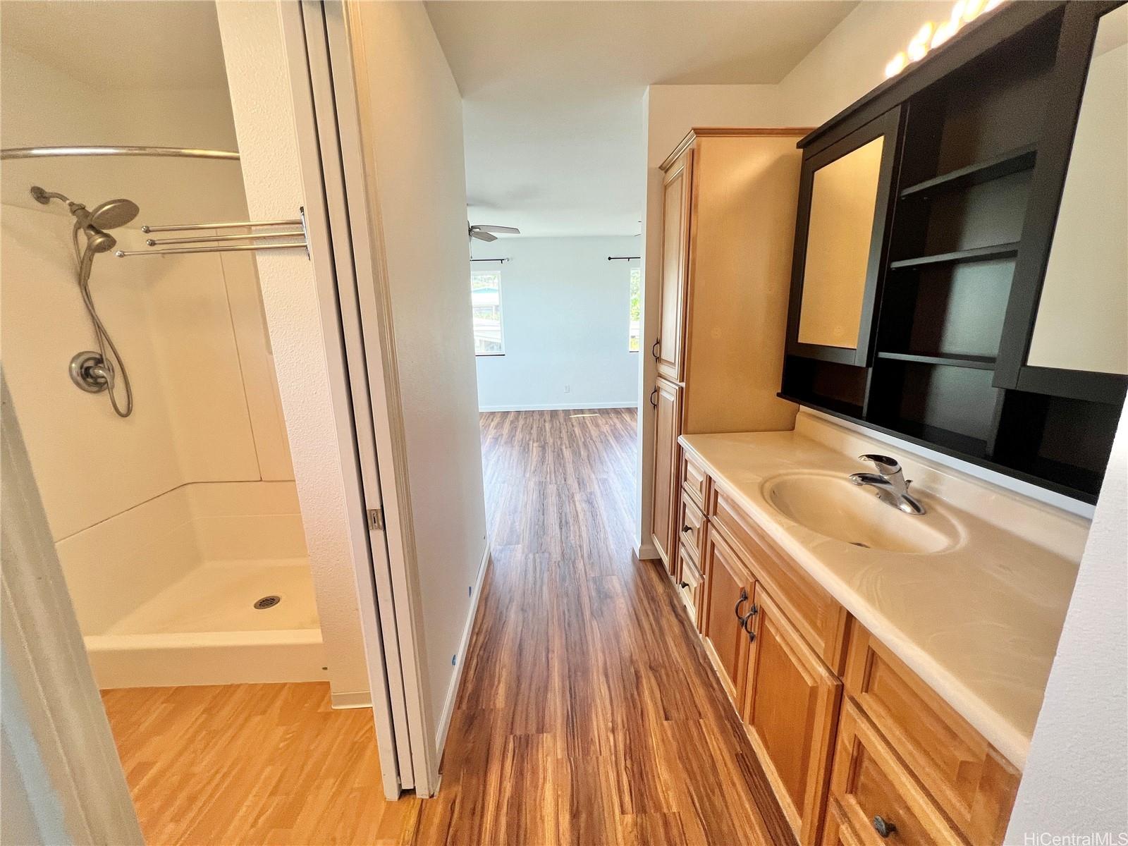 2407 Komo Mai Drive Pearl City, HI 96782 - Photo 17 of 25 a bathroom with a sink a mirror and a bathtub