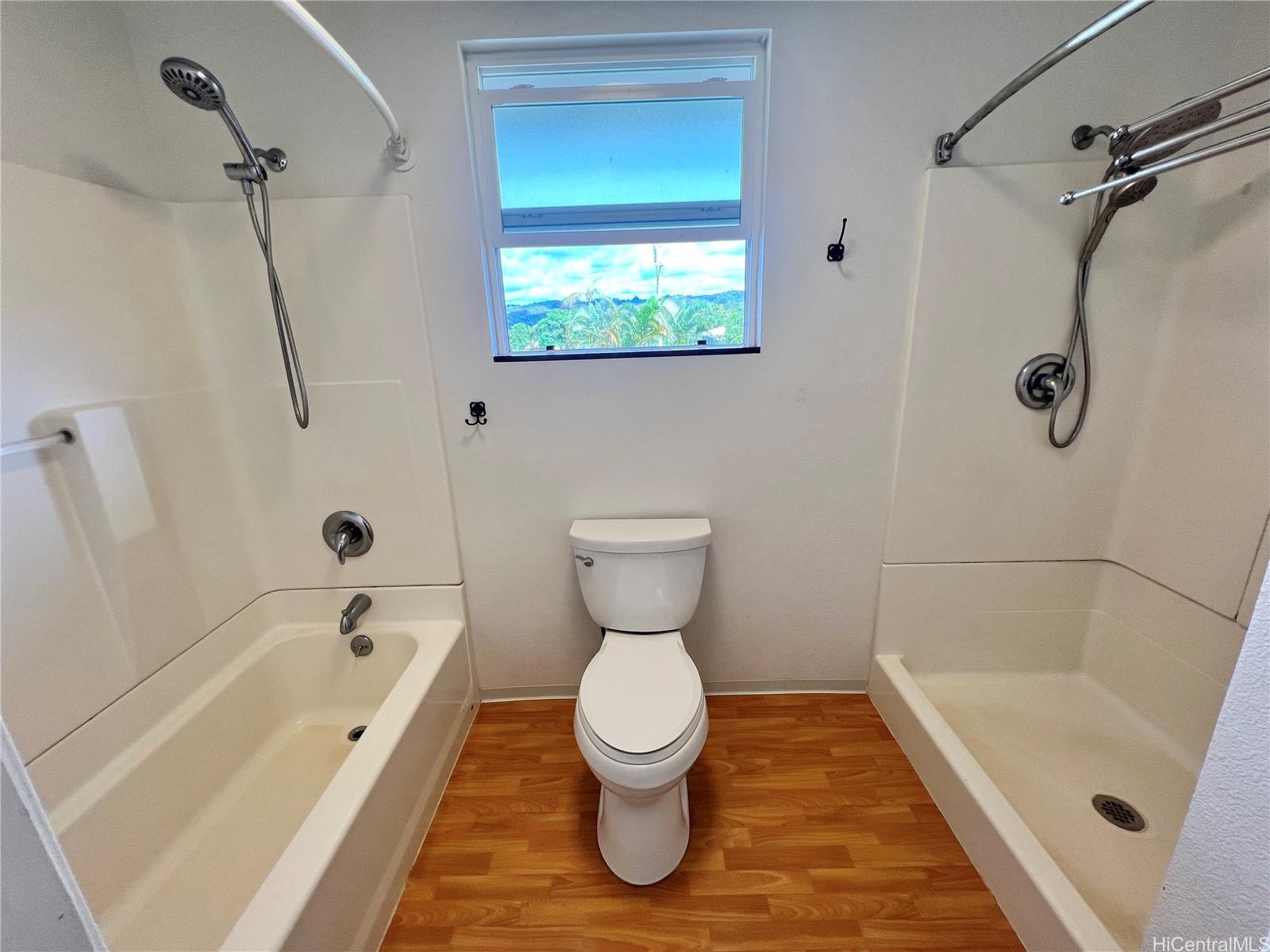 2407 Komo Mai Drive Pearl City, HI 96782 - Photo 18 of 25 a bathroom with a toilet and a bathtub