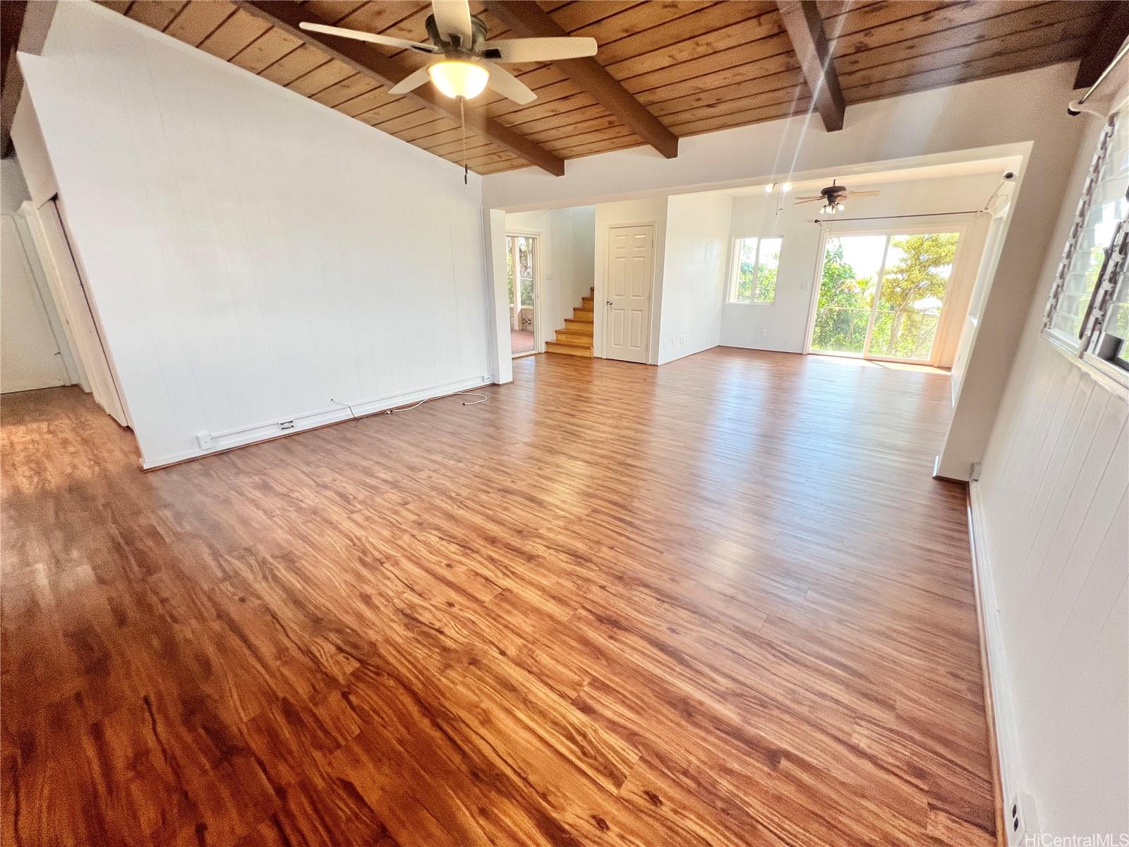 2407 Komo Mai Drive Pearl City, HI 96782 - Photo 2 of 25 a view of an empty room with wooden floor and a window