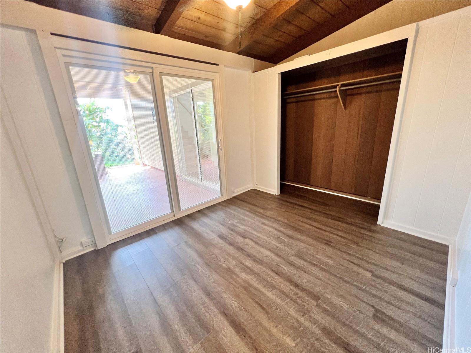 2407 Komo Mai Drive Pearl City, HI 96782 - Photo 7 of 25 an empty room with wooden floor and windows