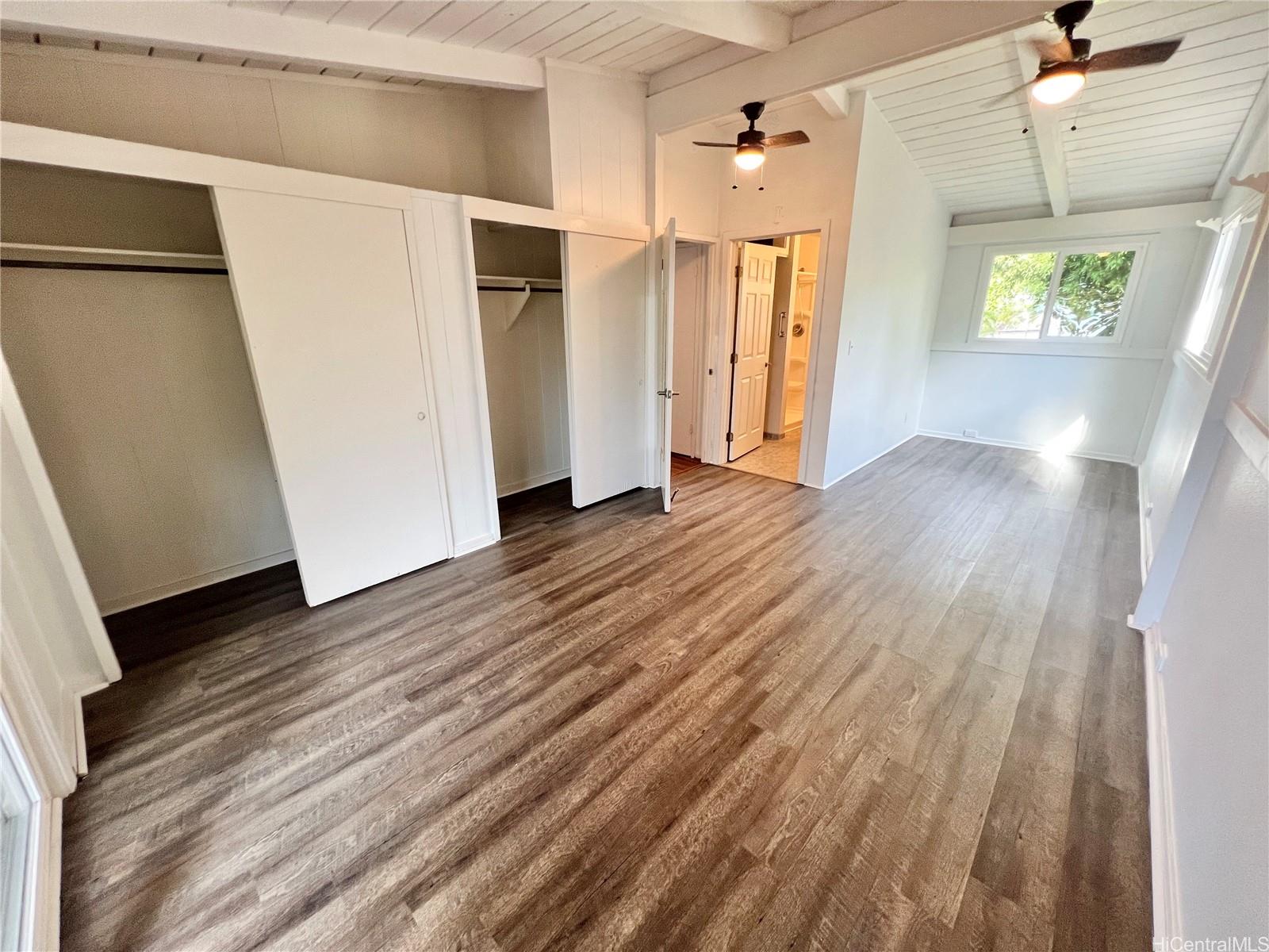 2407 Komo Mai Drive Pearl City, HI 96782 - Photo 9 of 25 a view of a hallway with wooden floor and staircase