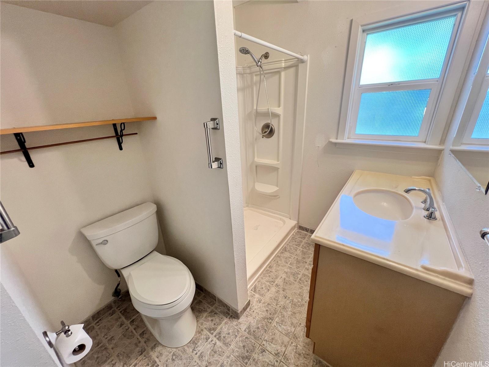 2407 Komo Mai Drive Pearl City, HI 96782 - Photo 10 of 25 a bathroom with a toilet sink and shower