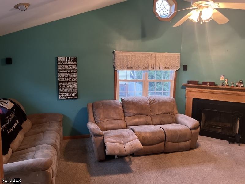 20 Nottingham Drive Howell, NJ 07731 - Photo 6 of 21 a living room with furniture a fireplace and a chandelier
