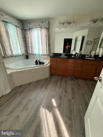 a bathroom with a bathtub and a sink