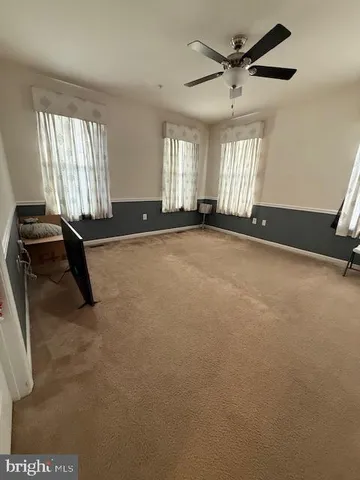 a view of a room with gym equipment and windows