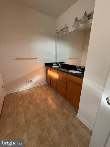 a kitchen with granite countertop a sink and a stove