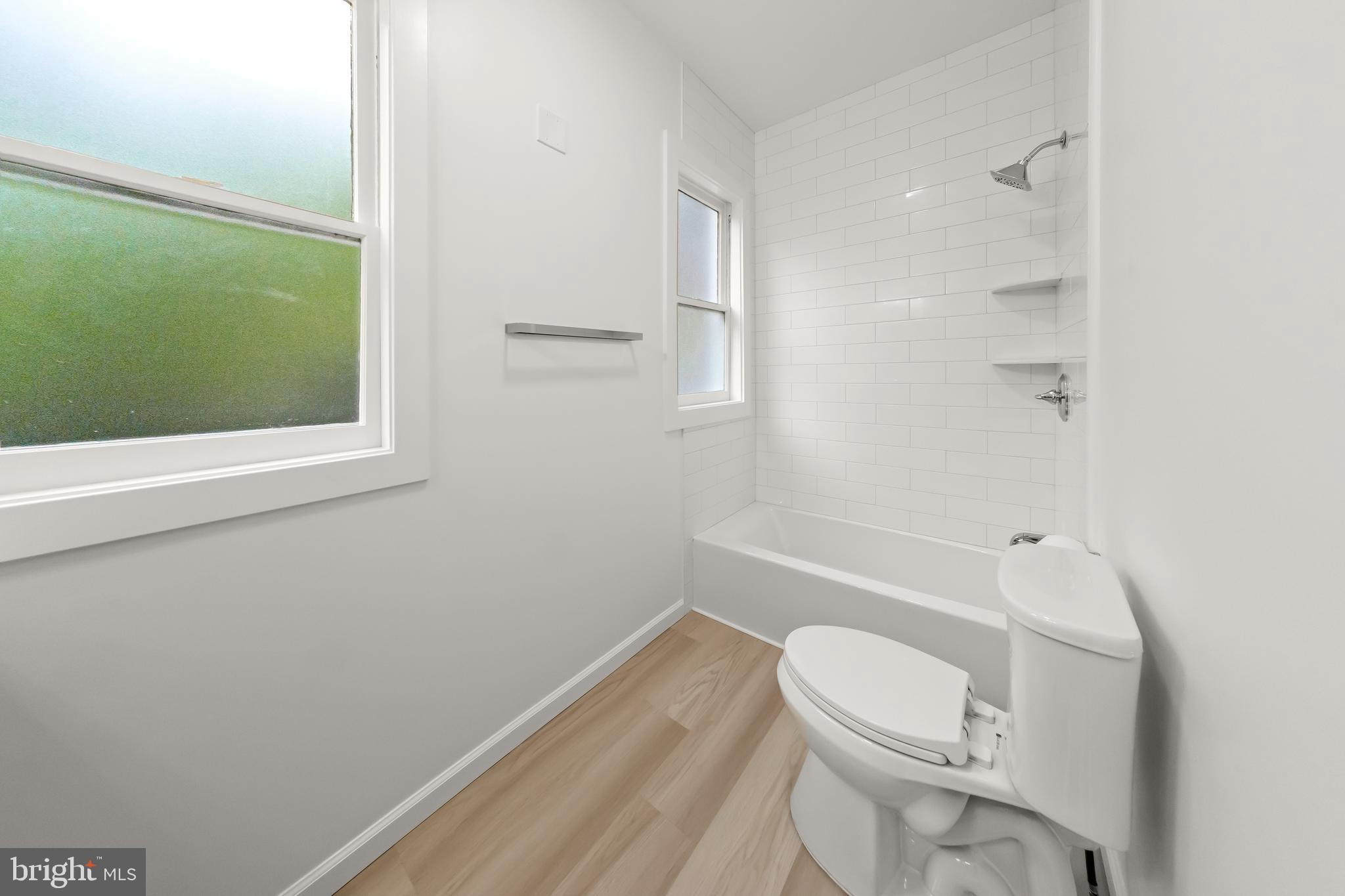 10220 Capitol View Avenue Silver Spring, MD 20910 - Photo 35 of 63 a white toilet sitting next to a bathroom sink and tub