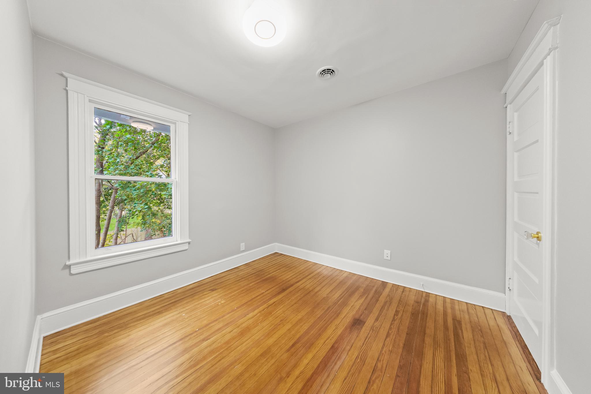 10220 Capitol View Avenue Silver Spring, MD 20910 - Photo 54 of 63 an empty room with wooden floor and windows