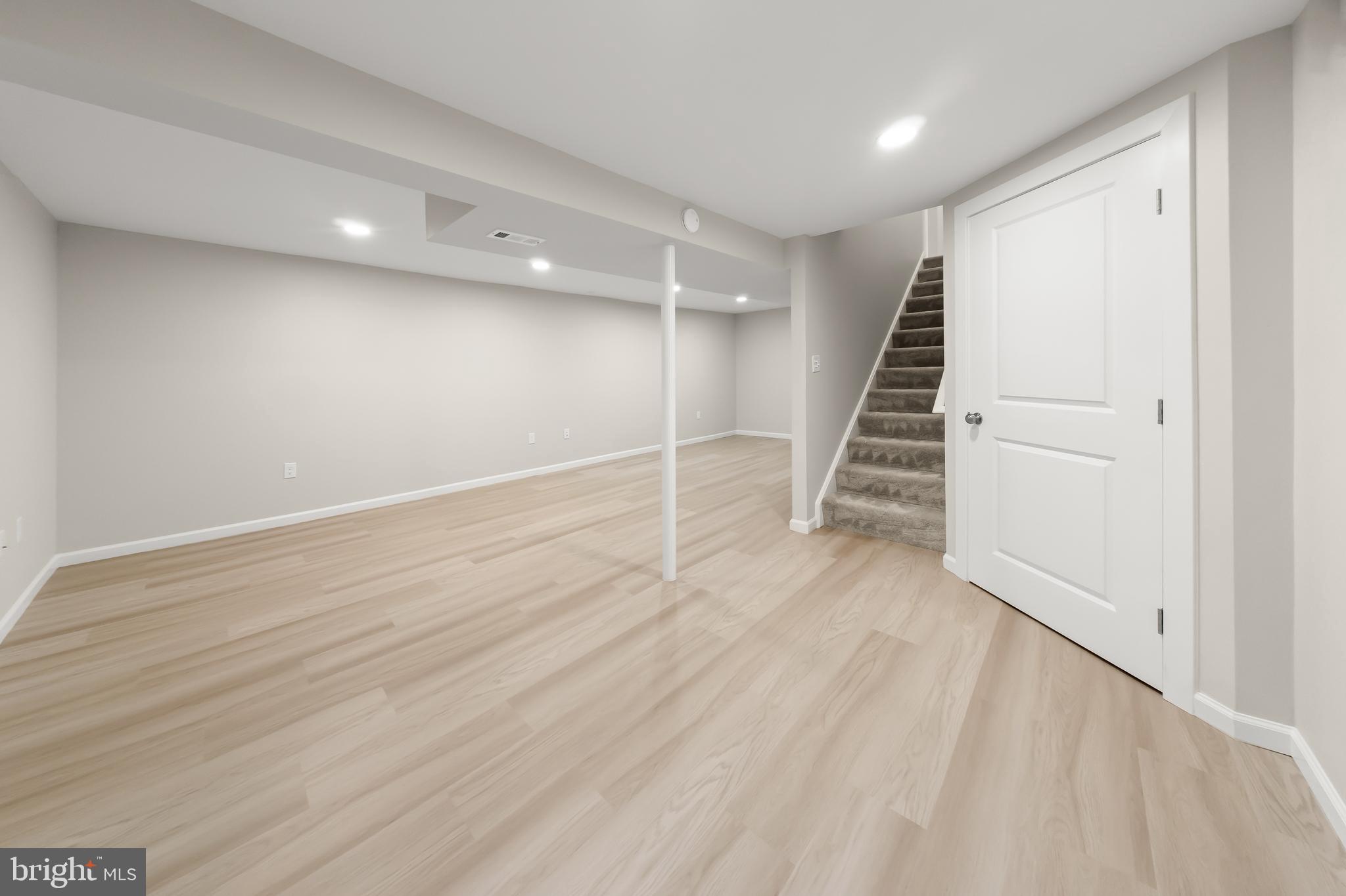 10220 Capitol View Avenue Silver Spring, MD 20910 - Photo 59 of 63 an empty room with wooden floor and staircase