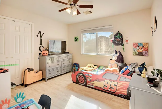 a bedroom with a bed and a chandelier