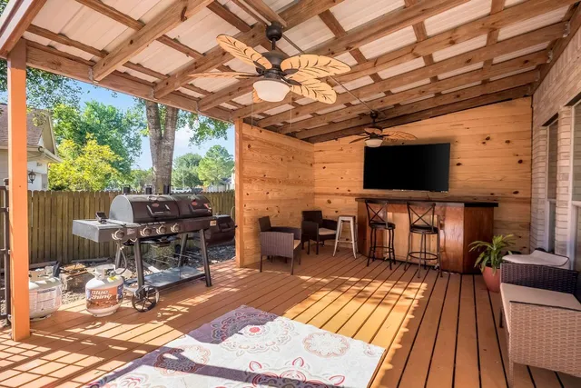 a outdoor living space with furniture and a flat screen tv