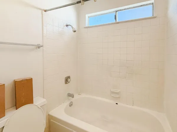 a bathroom with a bathtub and a shower