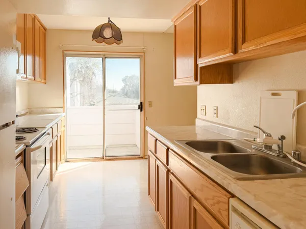 a kitchen that has a sink and a stove