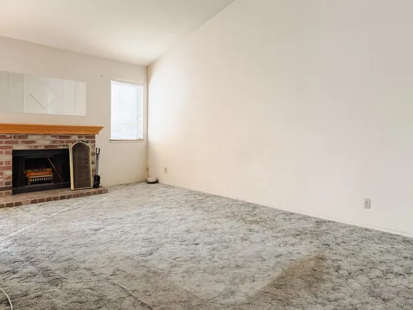 a view of empty room with a fireplace