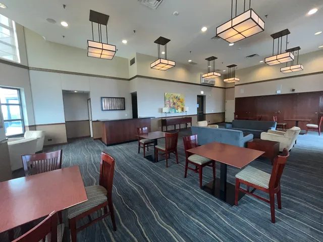 a roof deck with outdoor seating and city view