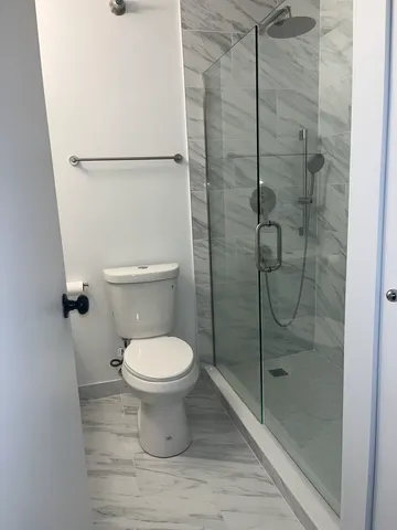a bathroom with a granite countertop sink and mirror