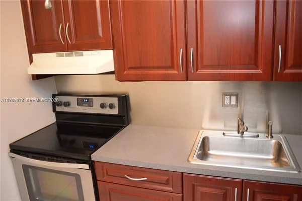a kitchen with cabinets appliances and a sink