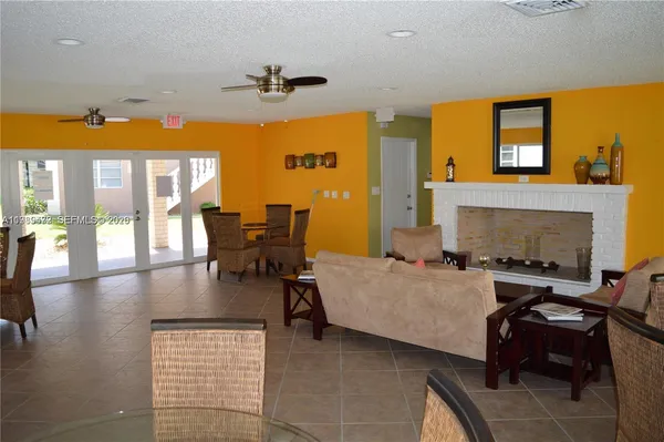 a living room with fireplace furniture and a large window