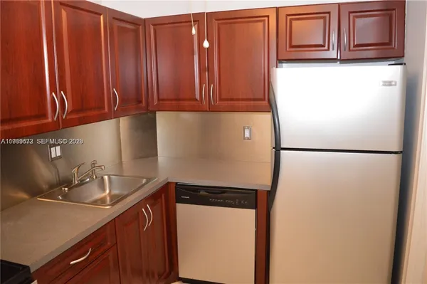 a kitchen with a sink and a refrigerator